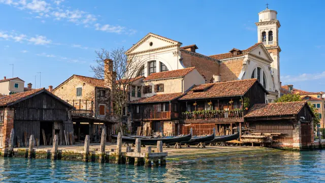 The squero of San Trovaso, a gondola boatyard with a timber roof beside a canal in Venice